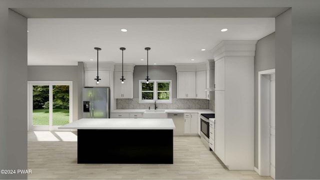 kitchen featuring pendant lighting, sink, a kitchen island, white cabinetry, and stainless steel appliances