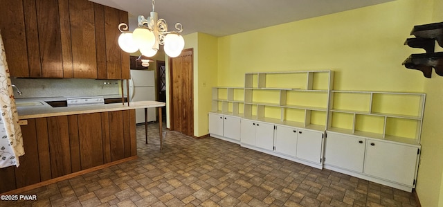 24 Buff Rd, Cochecton, Ny, NY 12726 - kitchen with white appliances, a chandelier, a sink, brick patterned floors, and light countertops