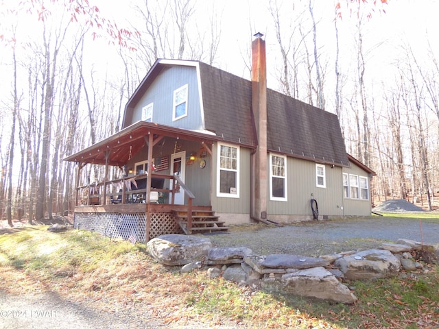 rear view of house featuring a deck