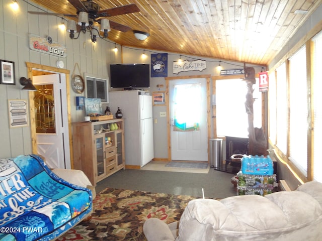 living room with lofted ceiling, carpet floors, wooden ceiling, and ceiling fan