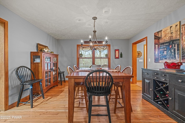 216 Comstock Dr, Lords Valley, PA 18428 - dining space featuring a textured ceiling, a chandelier, and light wood finished floors