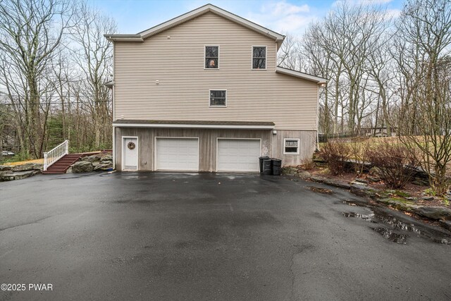 216 Comstock Dr, Lords Valley, PA 18428 - view of property exterior featuring asphalt driveway and a garage