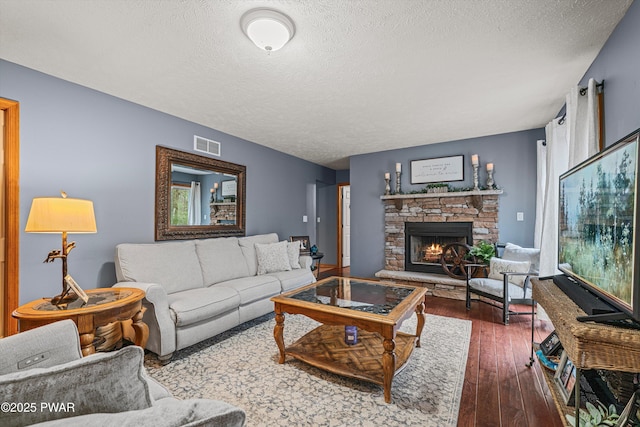 216 Comstock Dr, Lords Valley, PA 18428 - living area featuring a textured ceiling, hardwood / wood-style floors, and a fireplace
