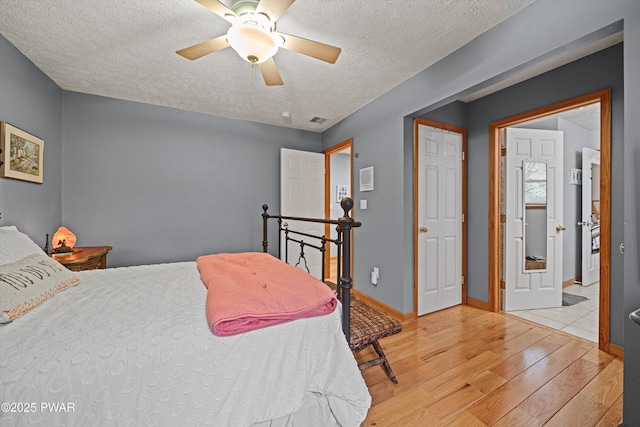 216 Comstock Dr, Lords Valley, PA 18428 - bedroom with hardwood / wood-style floors, a textured ceiling, and a ceiling fan