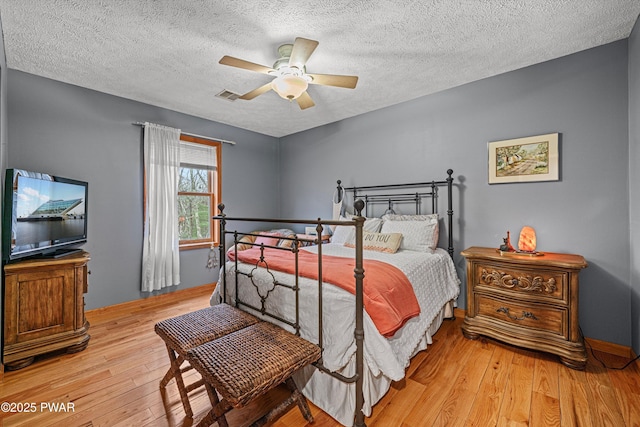 216 Comstock Dr, Lords Valley, PA 18428 - bedroom featuring hardwood / wood-style floors, a textured ceiling, and ceiling fan