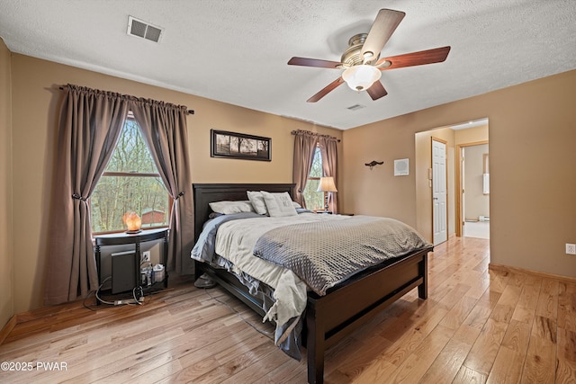 216 Comstock Dr, Lords Valley, PA 18428 - bedroom featuring light wood-type flooring, multiple windows, a textured ceiling, and ceiling fan