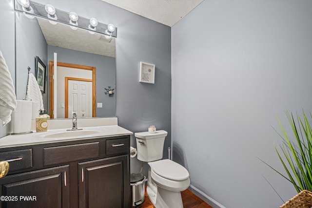 216 Comstock Dr, Lords Valley, PA 18428 - half bathroom featuring wood finished floors, vanity, and a textured ceiling