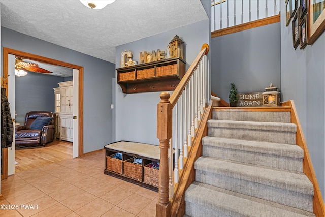 216 Comstock Dr, Lords Valley, PA 18428 - stairs featuring a textured ceiling and tile patterned floors