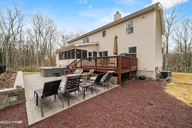 216 Comstock Dr, Lords Valley, PA 18428 - back of property featuring a sunroom, a patio area, a hot tub, and a wooden deck