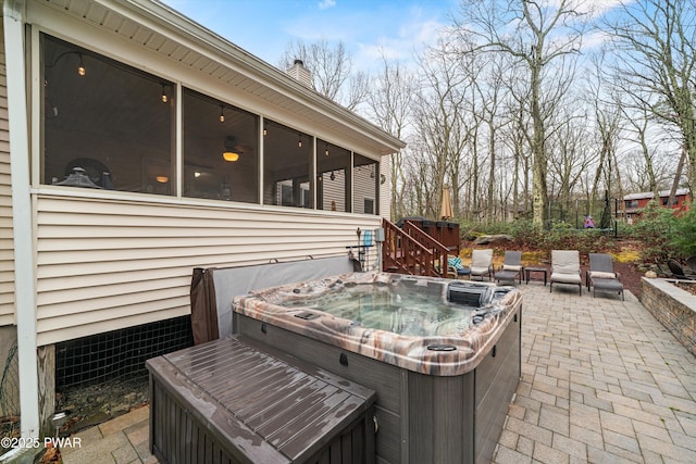 216 Comstock Dr, Lords Valley, PA 18428 - view of patio featuring a hot tub and a sunroom