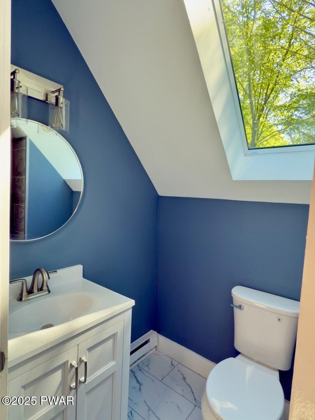 17 Applegate Rd, Lake Ariel, PA 18436 - half bathroom with a baseboard heating unit, marble finish flooring, toilet, vanity, and baseboards