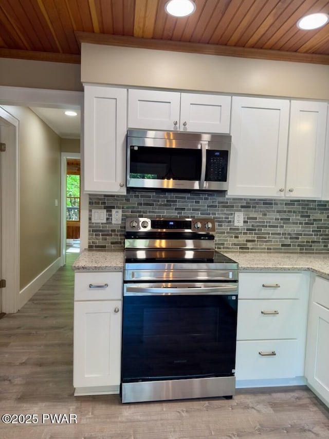 17 Applegate Rd, Lake Ariel, PA 18436 - kitchen featuring appliances with stainless steel finishes, wood ceiling, white cabinets, crown molding, and decorative backsplash