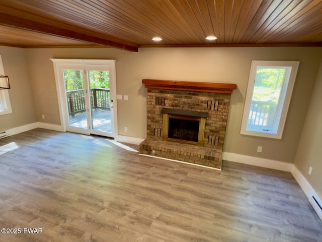 17 Applegate Rd, Lake Ariel, PA 18436 - unfurnished living room featuring plenty of natural light, a fireplace, wood ceiling, crown molding, and wood finished floors