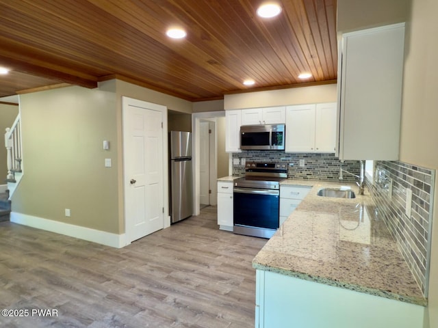 17 Applegate Rd, Lake Ariel, PA 18436 - kitchen featuring stainless steel appliances, a sink, wood ceiling, light stone counters, and white cabinetry