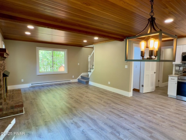 17 Applegate Rd, Lake Ariel, PA 18436 - unfurnished living room with baseboard heating, wooden ceiling, stairs, wood finished floors, and baseboards