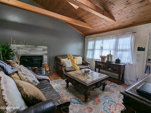 living room featuring hardwood / wood-style flooring, wooden ceiling, a tile fireplace, and lofted ceiling with skylight