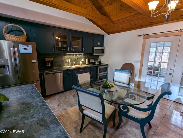 tiled dining area featuring vaulted ceiling with beams, a chandelier, sink, and wooden ceiling