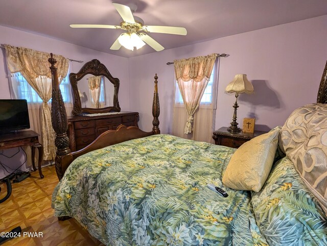 bedroom featuring parquet flooring and ceiling fan