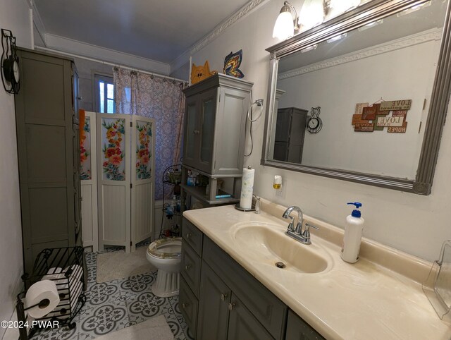 bathroom featuring a shower with shower curtain, vanity, toilet, and crown molding