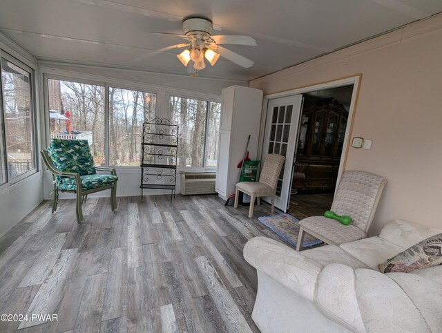 sunroom / solarium featuring a wall mounted air conditioner and ceiling fan