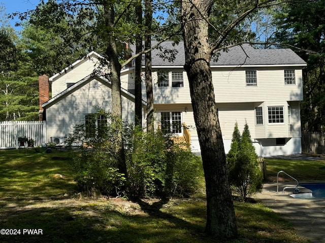 rear view of property with a yard