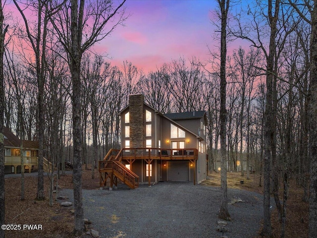 view of front of home with a garage and a wooden deck