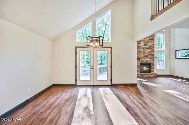 entryway featuring dark hardwood / wood-style flooring, french doors, high vaulted ceiling, and an inviting chandelier