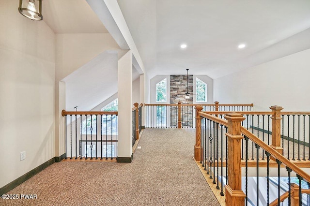 hallway featuring carpet flooring and vaulted ceiling