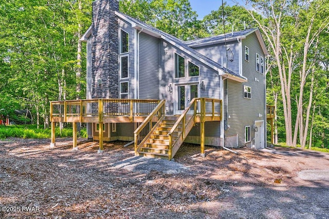 rear view of house with a wooden deck