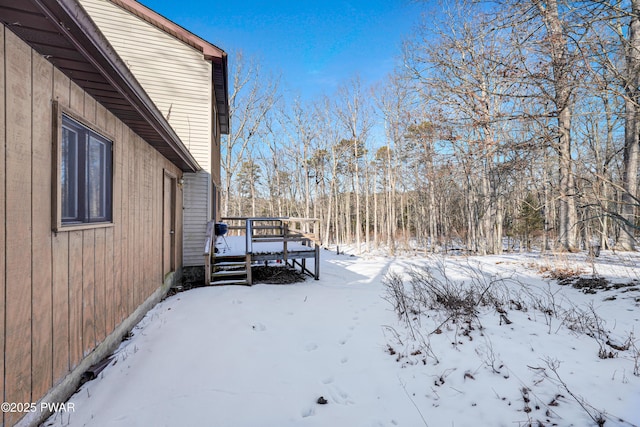 snowy yard with a deck