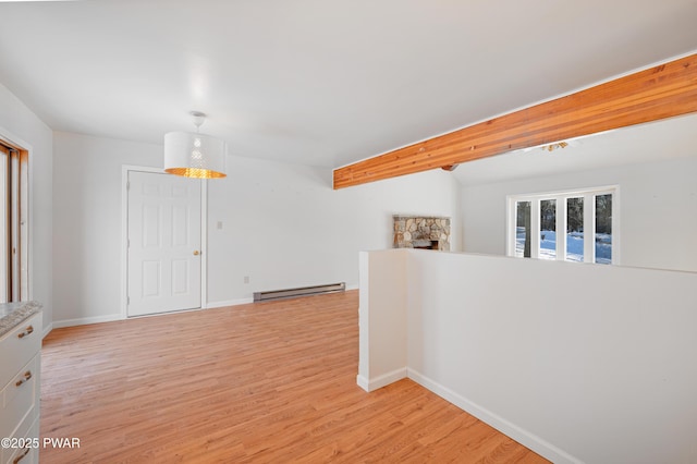 hall featuring baseboard heating and light hardwood / wood-style floors