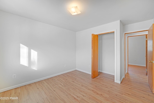 unfurnished bedroom with light hardwood / wood-style floors and a closet