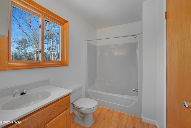 full bathroom with shower / tub combination, hardwood / wood-style floors, vanity, and toilet