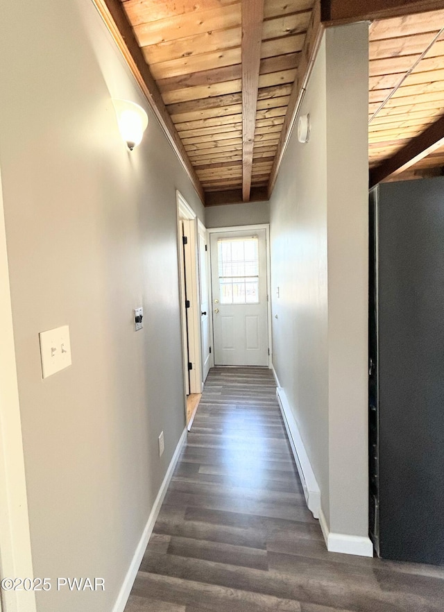 hall featuring wooden ceiling, a baseboard heating unit, baseboards, and wood finished floors