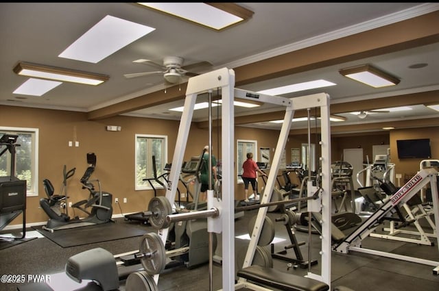 gym featuring crown molding, a ceiling fan, and baseboards