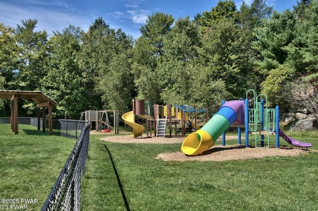 community playground featuring a lawn and fence