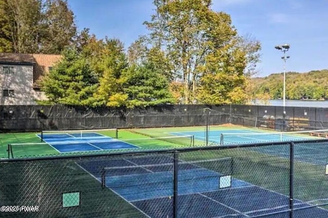 view of tennis court with fence