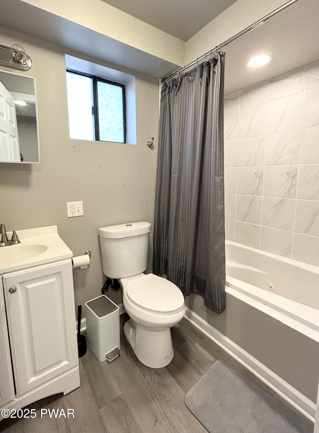 full bathroom featuring vanity, toilet, shower / bath combo with shower curtain, and wood finished floors