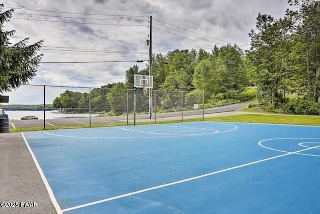 view of basketball court with community basketball court and fence