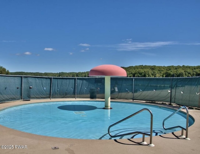 view of pool with a fenced in pool and fence