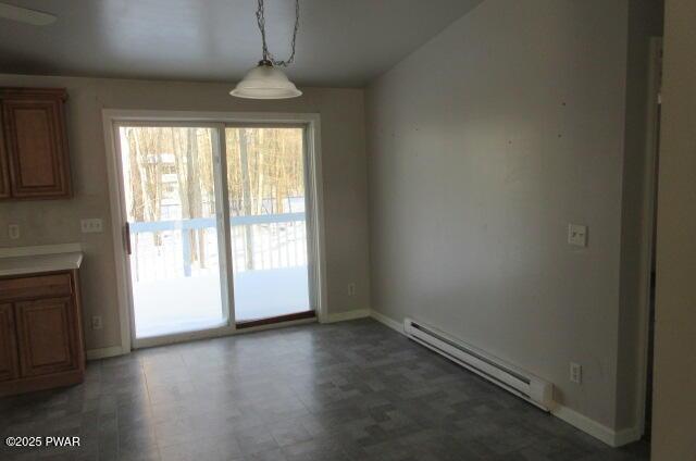 unfurnished dining area with baseboard heating