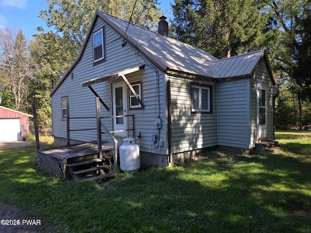 10 Kane Rd, Starlight, PA 18461 - rear view of property with an outbuilding, a detached garage, a chimney, and a yard