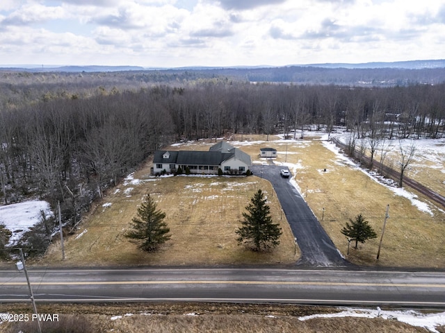 birds eye view of property featuring a view of trees