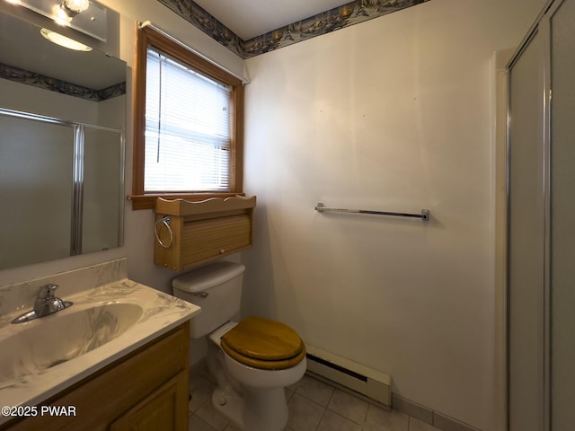 bathroom with toilet, a baseboard heating unit, vanity, a shower stall, and tile patterned floors