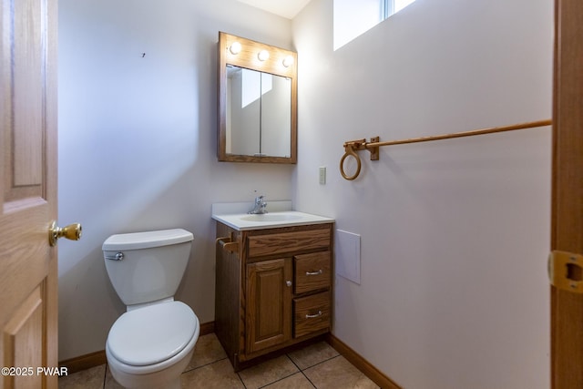 bathroom with baseboards, vanity, toilet, and tile patterned floors