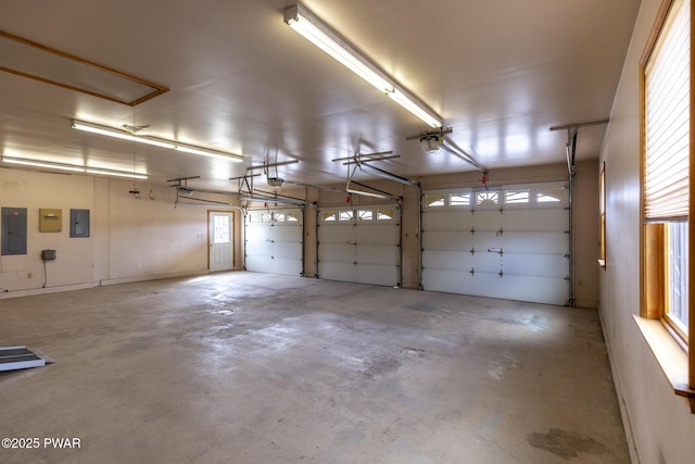 garage featuring electric panel and a garage door opener