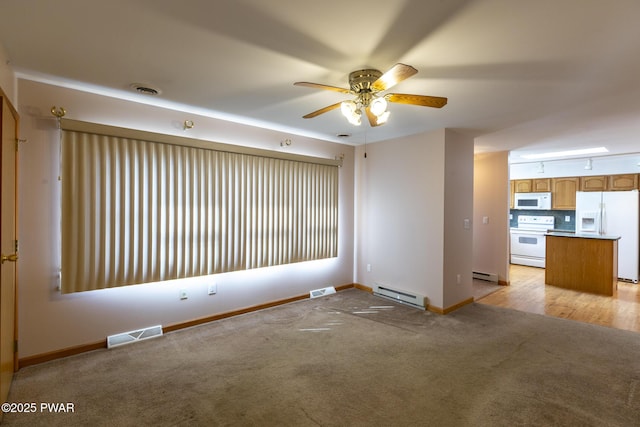 interior space with a baseboard radiator, light colored carpet, and visible vents