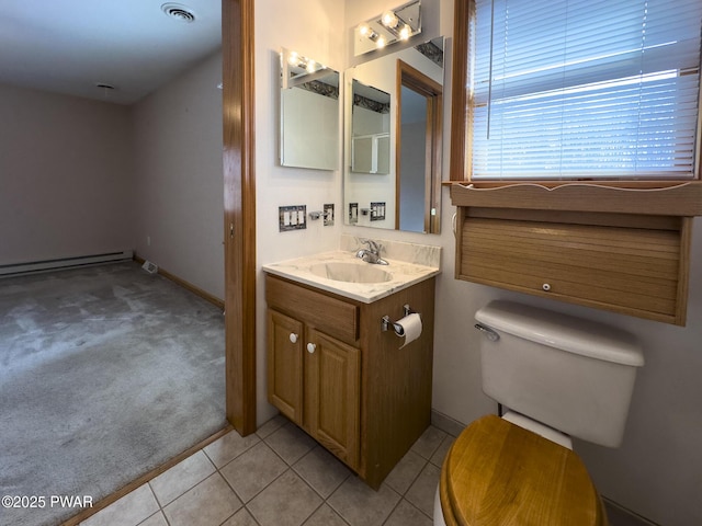 half bath featuring toilet, a baseboard heating unit, visible vents, vanity, and tile patterned floors