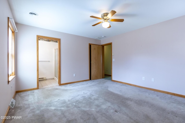 carpeted empty room featuring a baseboard heating unit, baseboards, visible vents, and ceiling fan