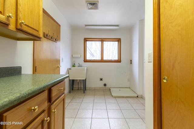 bathroom with tile patterned flooring, visible vents, and baseboards